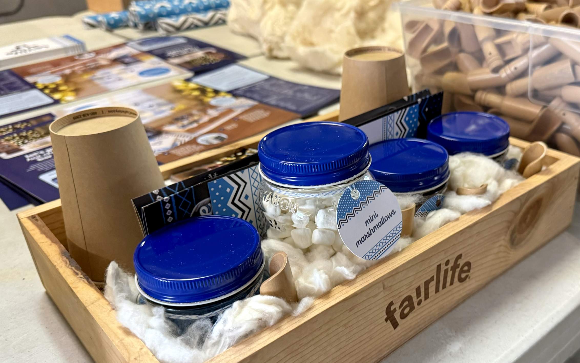 Close up of a fully packed fairlife Hot Chocolate wooden tray with other kit items in the background