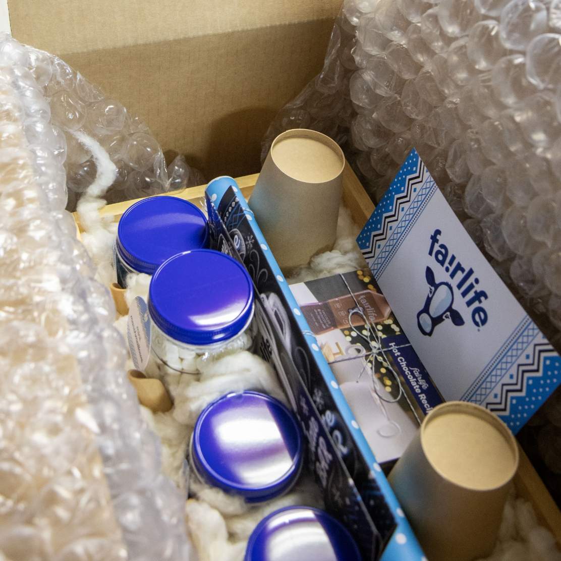 Fully loaded fairlife hot chocolate kit displayed in a bubble wrapped lined mailing box